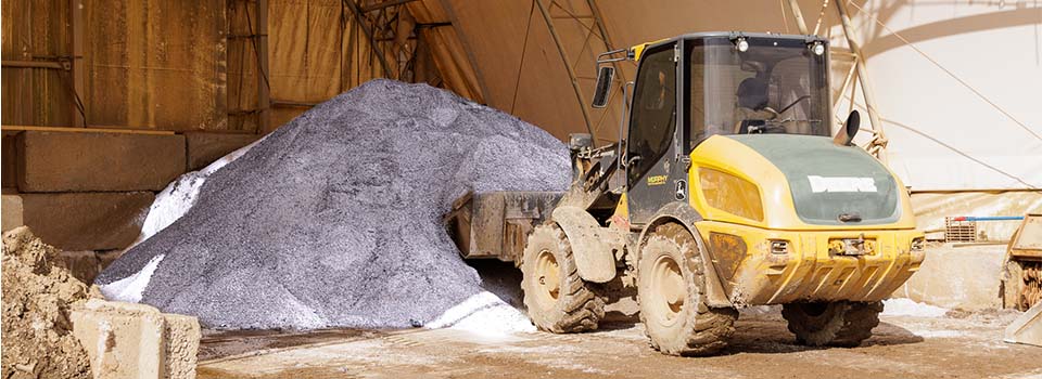Machine picking up bulk rock salt